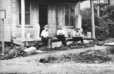 Samuel Harbison, William Scott, John Hauserman sitting outside a house